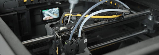 1. Screwdriver loosening the X2D toolhead screws during PTFE tube repair.