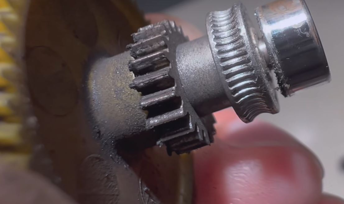 close-up of a worn extruder gear showing drive-tooth wear