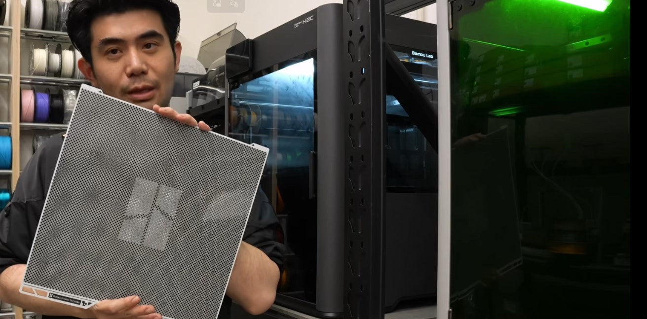 BIG BRO holding the Bambu Vision Encoder calibration plate for H2D motion accuracy calibration
