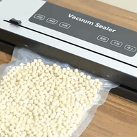  Filament vacuum sealer removing air from a bag of molecular sieve desiccant for dry filament storage.