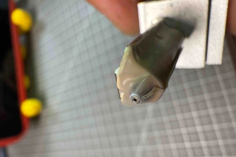A hotend nozzle wrapped in messy PTFE tape, a tedious alternative to using a dedicated P2S Nozzle Brush.